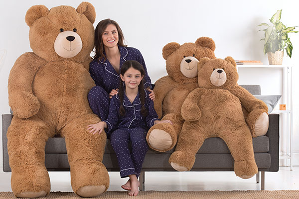 An image of a woman and a child sitting with a 4-foot Big Hunka Love Bears
