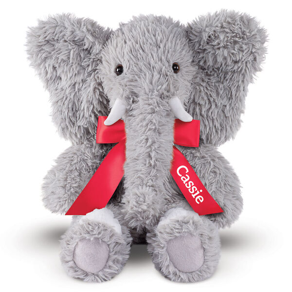 18" Oh So Soft Elephant - Front view of seated gray Elephant with gray foot pads and white tusks and toe nails wearing a red satin bow with tails personalized with "Cassie" in white lettering
