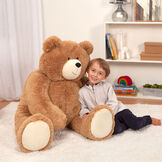 4' Big Hunka Love Bear - Seated golden brown bear with a child model in a bedroom scene image number 5