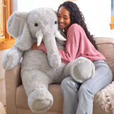 4' Cuddle Elephant - Front view of seated grey plush elephant with woman on couch image number 0