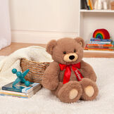 18" Oh So Soft Teddy Bear - Front view of seated honey brown bear with red satin bow in a living room scene image number 4