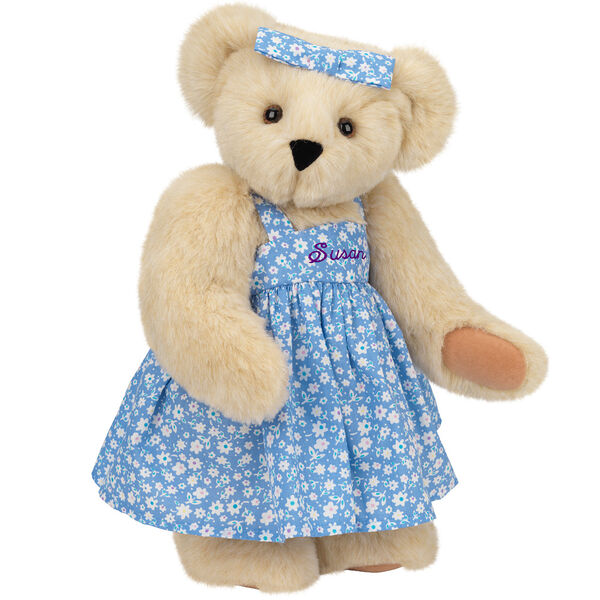 15" Mother Bear - Three quarter view of standing jointed bear dressed in blue floral dress and hair bow personalized with "Susan" in purple on bodice of dress - Buttercream brown fur