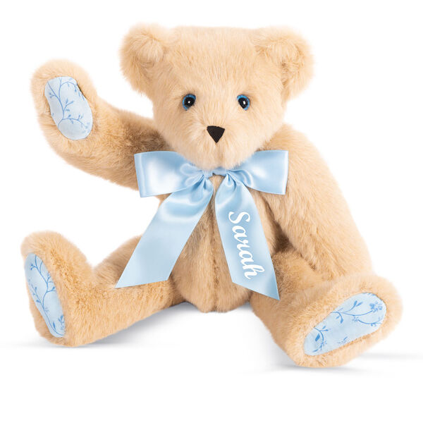 15" Bluebell Blossoms Bear - 15" seated jointed buttercream bear with blue eyes and blue floral paw pads with personalization on the blue satin bow