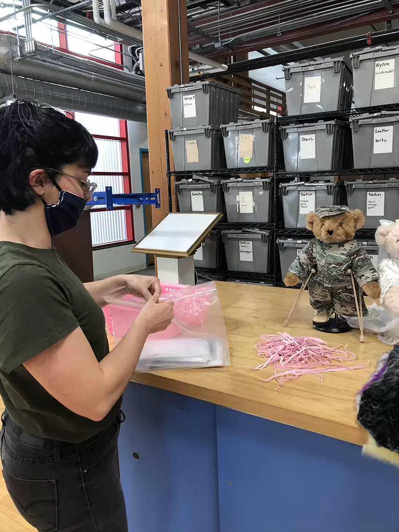 An image of a worker making a teddy bear
